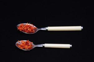 Metal spoons with red spice photo