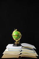 Globe on stacked books photo