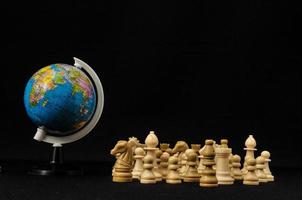 Chess pieces with globe photo