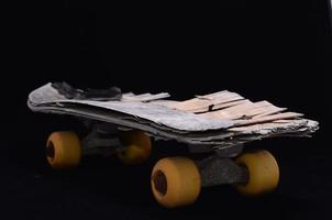 Isolated skateboard on dark background photo