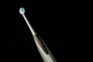 Toothbrush on black background photo