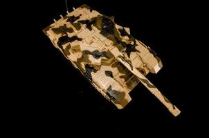 Camo tank on black background photo