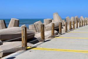 The breakwater protects the beach on the seashore from big waves. photo