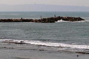 The breakwater protects the beach on the seashore from big waves. photo