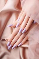 Girl's hands with a soft purple manicure. photo