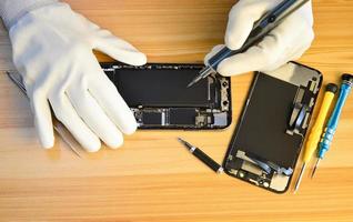 Top view of a technician repairing a smartphone photo