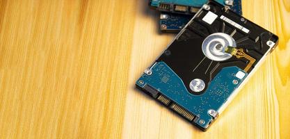 Close-up side view of hard disk on wooden floor photo