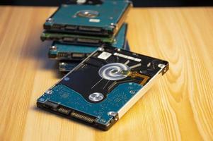 Close-up side view of hard disk on wooden floor photo