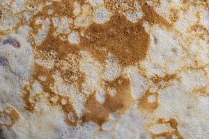 Pancake surface texture and pattern. Close-up of thin hot pancakes in a plate. Traditional rustic food. Graphic resource. photo