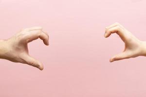 Woman and man hands showing heart shape. Concept love and relationships photo