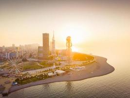 Dramatic evening in Batumi from aerial perspective with beautiful architecture buildings in foreground and setting sun in background. Georgia travel destination 2023 photo