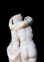 Togetherness emotion. Statue of two people embracing with passion photo