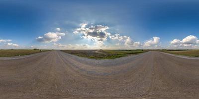 full seamless spherical hdri 360 panorama view on no traffic gravel road among fields with overcast sky and white clouds in equirectangular projection,can be used as replacement for sky in panoramas photo