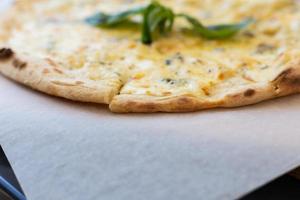 Fragrant Italian pizza of four cheeses - parmesan, dor blue, mozzarella, cheddar, Close up. photo