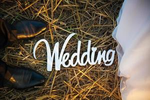 Feet of groom and bride. White wedding letters photo