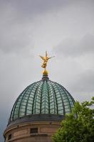 Golden angel statue with trumpet on the top photo