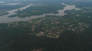 View from the window of an airplane descending to land over the city on a summer day video