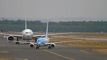 FRANKFURT AM MAIN, GERMANY JULY 20, 2017 - Cathay Pacific Boeing 777 B KPU towing from service and TUI Fly Boeing 737 taxiing. Fraport, Frankfurt, Germany video