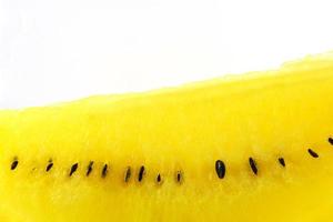 Close up of yellow watermelon and seed isolated on white background photo