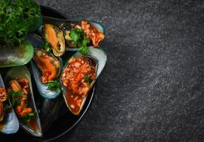 Mussel cooking pan seafood plate with Shellfish green mussels shell ocean gourmet dinner cooked photo