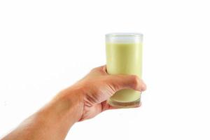 Soy milk in glass on hand isolated on white background photo