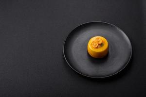 Delicious fresh tartlet with citrus filling and decorated with passion fruit photo