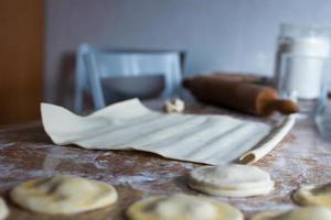 Kitchen table during dumplings preparation photo