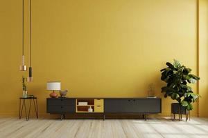 gabinete negro para interior de tv maqueta de pared amarilla. foto