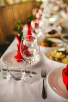 Restaurant interior, serving, wine and water glasses, plates. Concept banquet, birthday, conference, group lunch photo