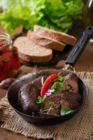 Homemade blood sausage with offal on the old wooden background in rustic style photo