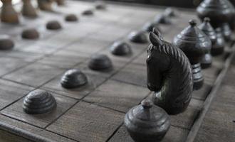 Ancient chess pieces made of wood photo