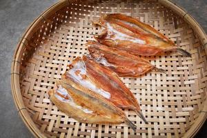 Making dried fish dry salted fish on threshing basket background photo