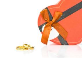 Close up gold rings and heart-shaped on white photo