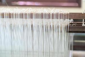 Weave silk cotton on the manual wood loom photo