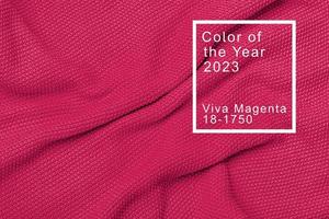 The texture of warm knitted sweater. Beautiful handmade knitted repeating pattern. Demonstrating Pantone color of the year 2023 viva magenta photo