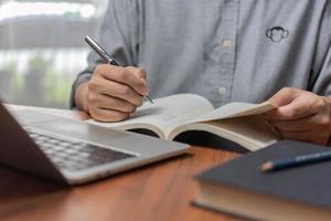 learning online class by using laptop computer and writing notebook at workplace, Education development or knowledge improvement concept. photo