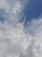 Beautiful white clouds on deep blue sky background. Elegant blue sky picture in daylight. Large bright soft fluffy clouds are cover the entire blue sky. photo