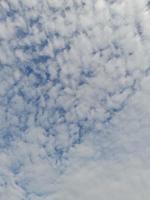 Beautiful white clouds on deep blue sky background. Elegant blue sky picture in daylight. Large bright soft fluffy clouds are cover the entire blue sky. photo