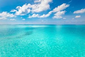 Summer sea beautiful of exotic tropical beach. Emerald green of the sea and bright blue sky with clouds with sunlight. Summer seascape, turquoise ocean water, idyll island or beach banner photo