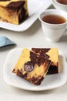 Slice of Marble Travel Cake, Square Cake with Melted Chocolate on the Center. photo