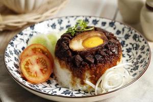 Nasi Tim Ayam Telur Asin, Steamed Rice with Salted Egg. photo