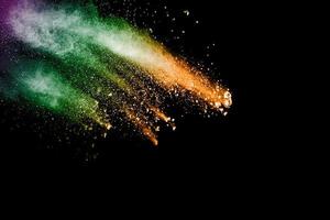 Multicolored powder explosion on black background. photo