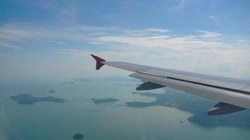 Airplane flight. Wing of an airplane flying above the clouds. View from the window of the plane. Aircraft. Traveling by air video