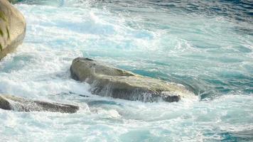 Turquoise waves rolled on the rocks, beach of Koh Miang island, Similan Islands, slow motion video