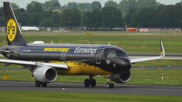 DUSSELDORF, GERMANY JULY 22, 2017 - Eurowings Airbus 320 D AIZR Borussia Dortmund livery taxiing before departure. Dusseldorf airport video