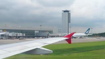 changi, singapur 22 de noviembre de 2018 - terminal 4 en el aeropuerto de changi vista desde el avión de rodaje airasia, aviones estacionados cerca de la terminal. video