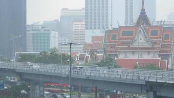 aerial view of bangkok skyline with many highrise skyscraper building with som traffic on the express way in raining thunderstorm time video