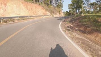 front driver view while traveling on the local road surround with pine trees high land forest in winter sunset time, traveling through pine forest video