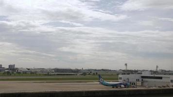 boeing b737 airplane park in airport bay area while ground service operating and airplane take off from airport video