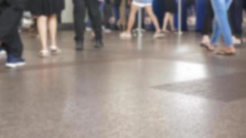 defocused blurred low angle view to feet with crowd of people moving travel on the transition to the metro, defocused blurred background, public transportation video